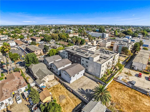 an aerial view of a residential apartment building with parking space