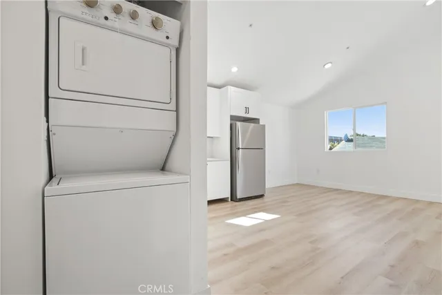 a view of washer and dryer with refrigerator