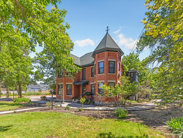 12825 South Fort Street Draper, UT 84020 - Photo 2 of 52 Brick exterior featuring a prominent turret with a dark shingle roof and decorative finial