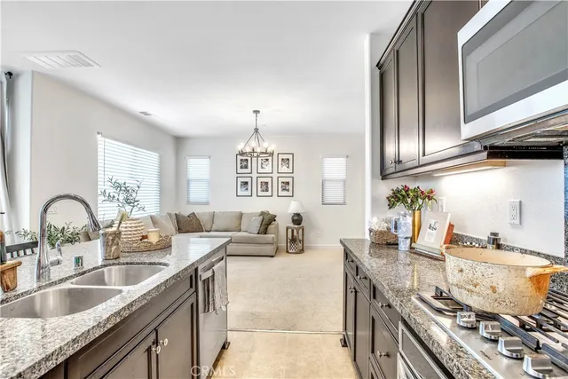a kitchen with granite countertop a sink and a stove