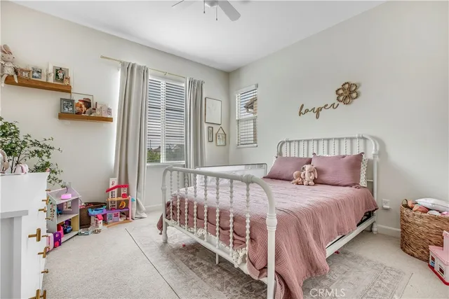 a bedroom with bed and a chandelier