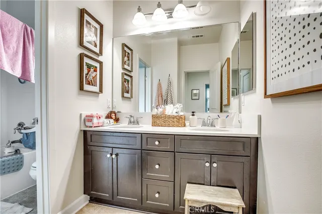a bathroom with a sink vanity and mirror