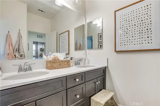 a bathroom with a sink a vanity and a mirror