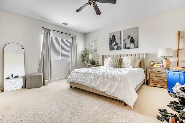 a bed room with a bed and a chair