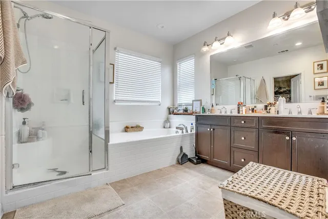 a bathroom with a tub a sink shower and mirror