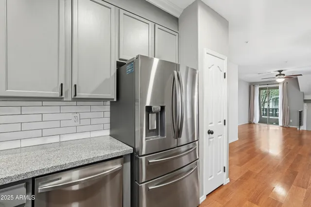 a kitchen with stainless steel appliances granite countertop a refrigerator and a sink