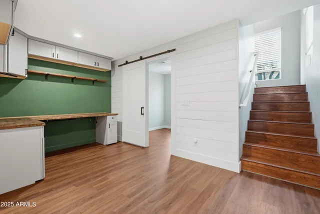 a room with hard wood floors and a window