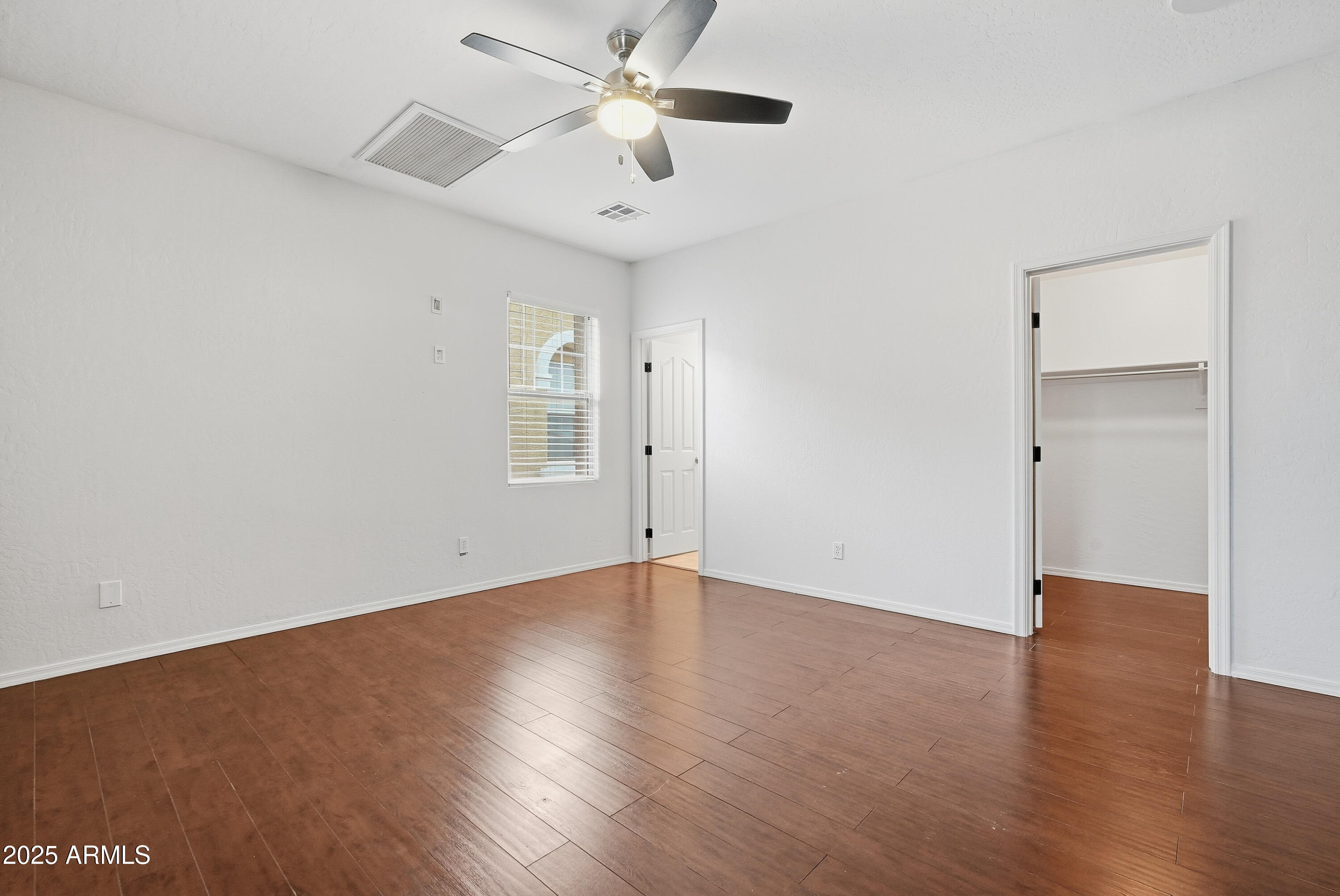 162 West Commerce Court Gilbert, AZ 85233 - Photo 20 of 29 an empty room with wooden floor ceiling fan and windows