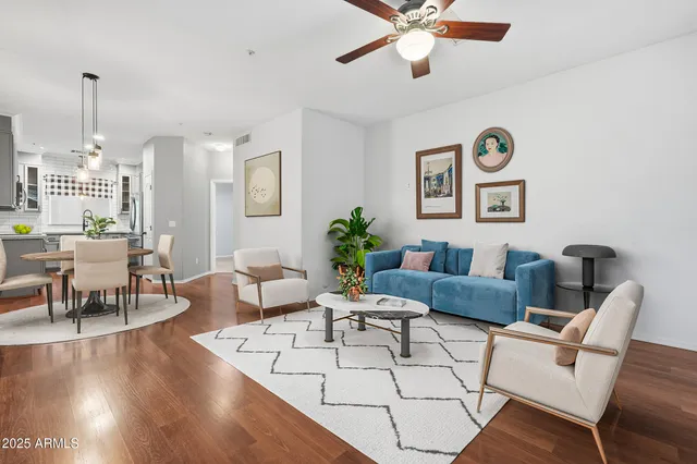a living room with furniture and a chandelier
