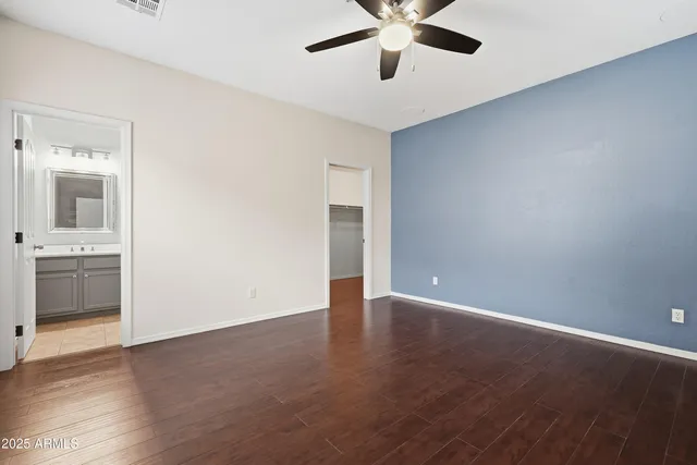 an empty room with a bathroom and a sink