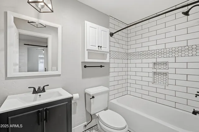 a bathroom with a sink toilet vanity and bathtub