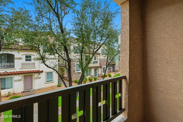 a balcony of a house with wooden floor and outdoor seating