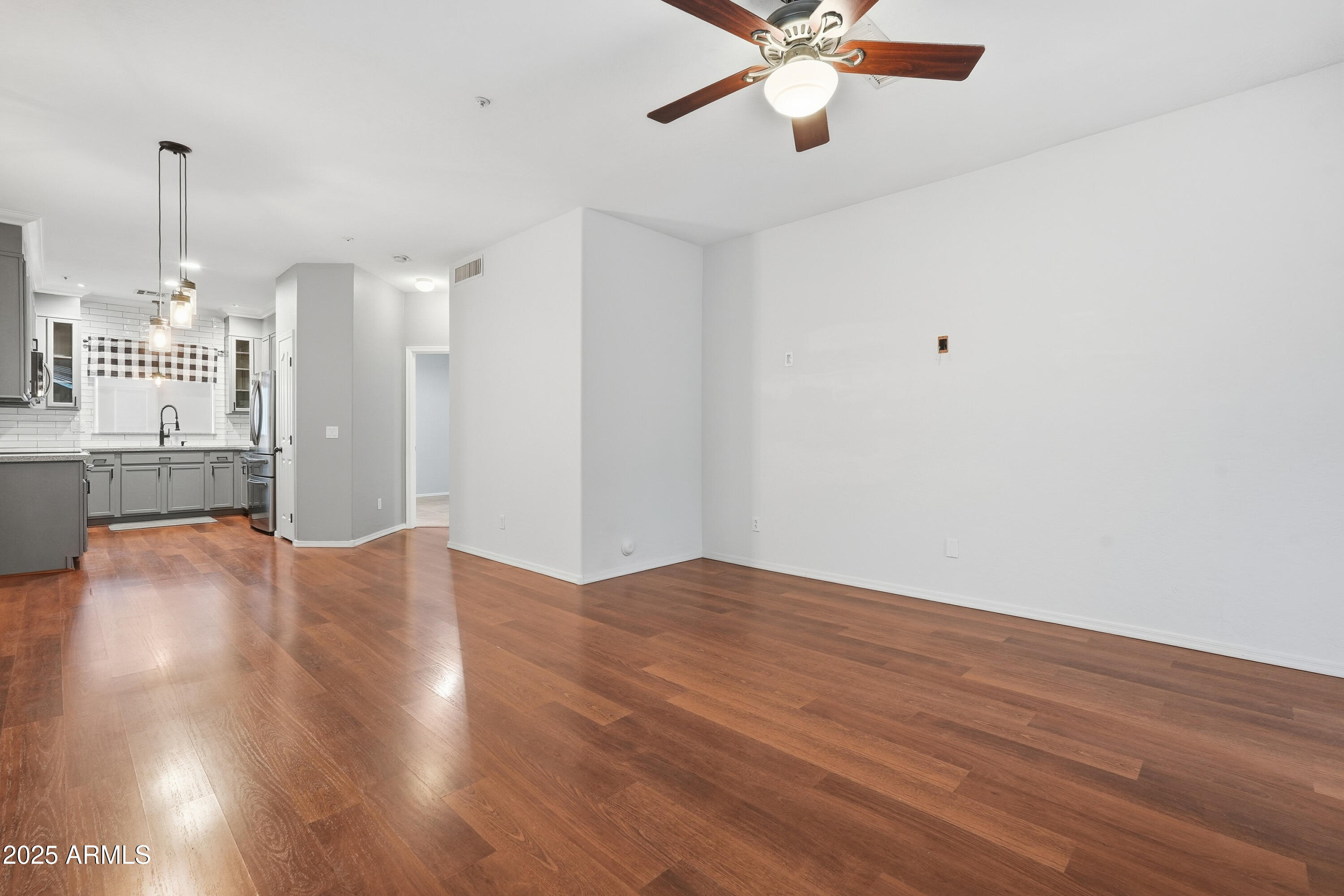 162 West Commerce Court Gilbert, AZ 85233 - Photo 4 of 29 a view of an empty room with wooden floor and a ceiling fan