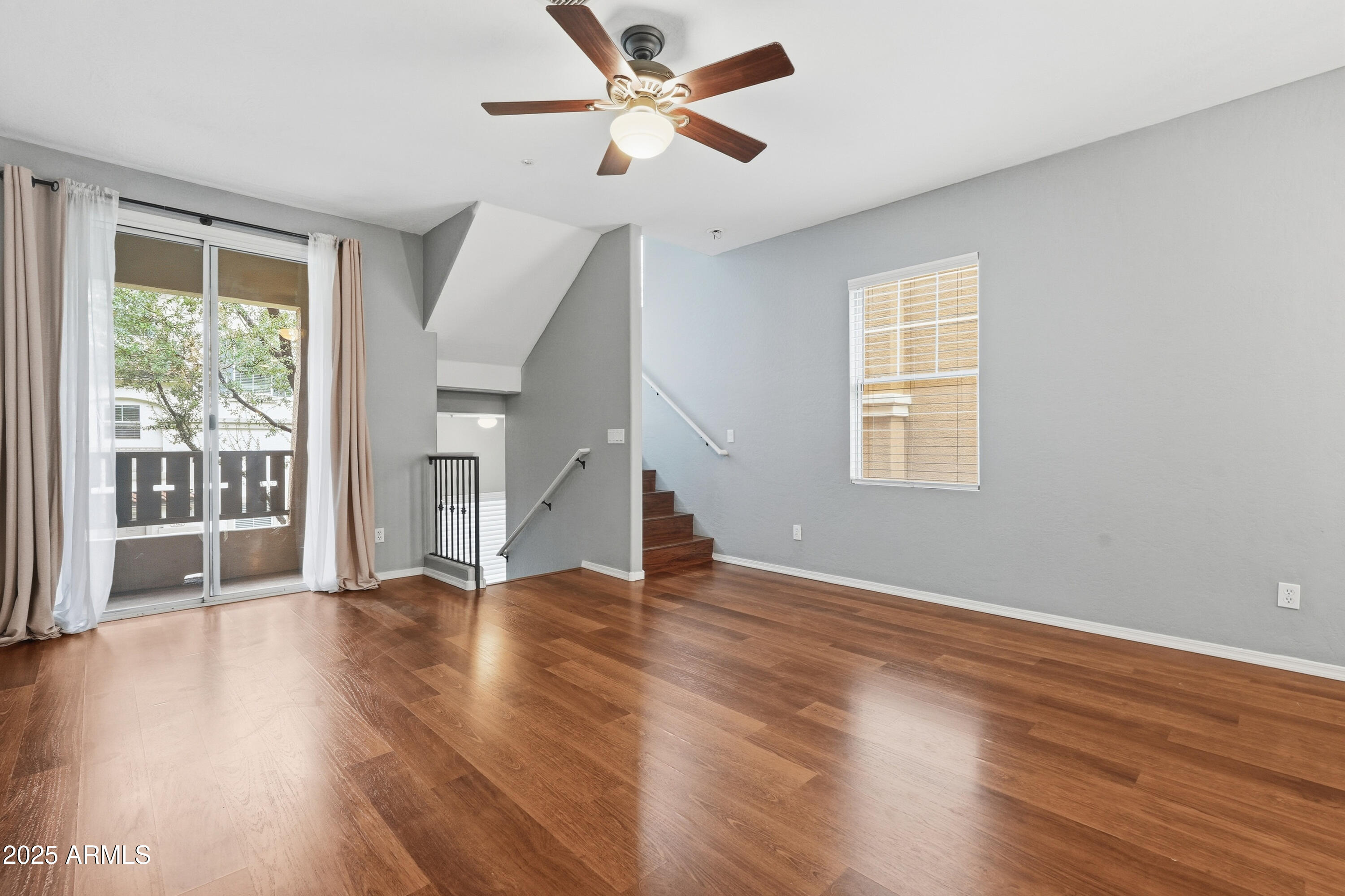 162 West Commerce Court Gilbert, AZ 85233 - Photo 6 of 29 a view of an empty room with wooden floor and a window