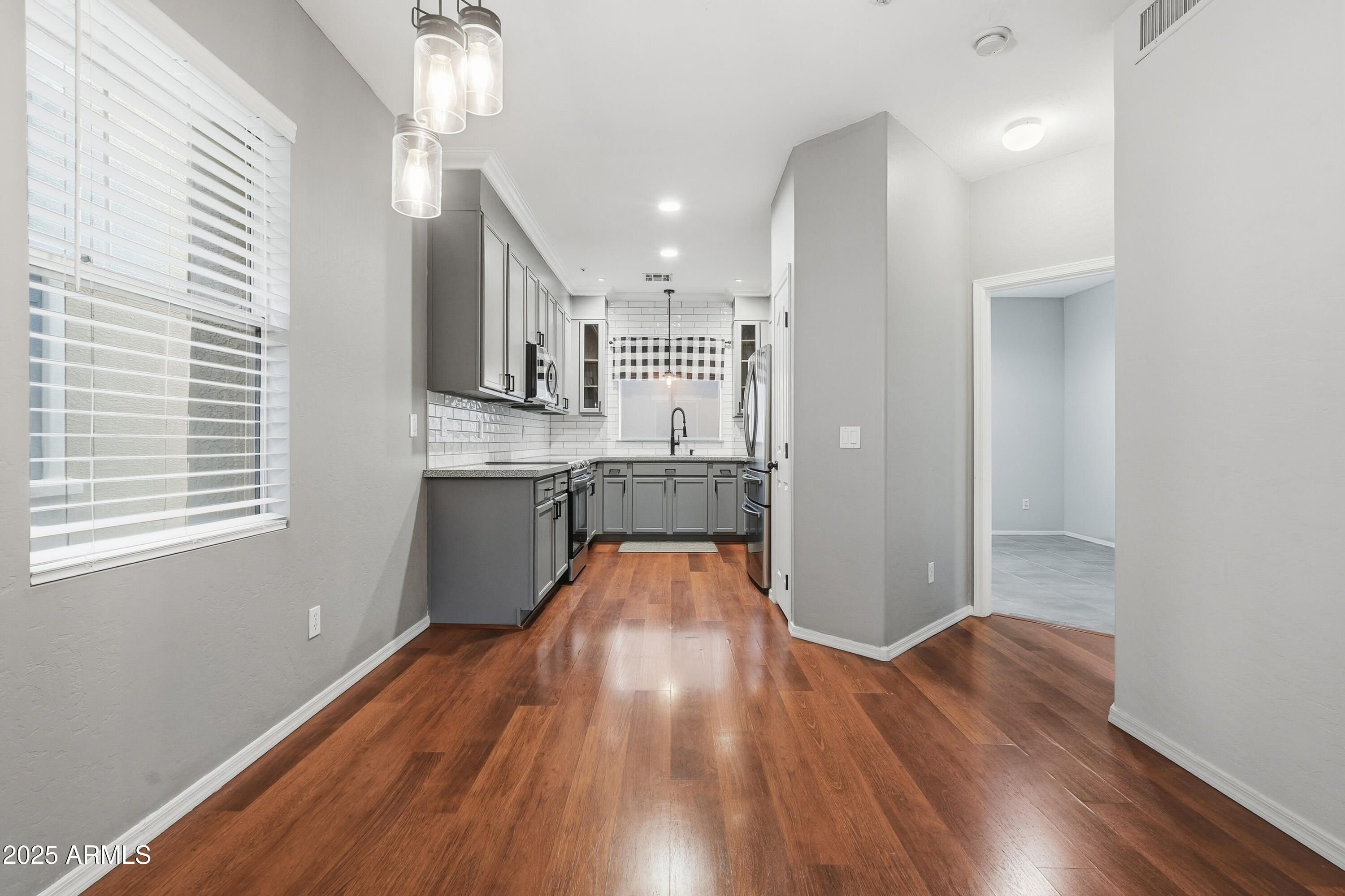 162 West Commerce Court Gilbert, AZ 85233 - Photo 8 of 29 a view of a kitchen with wooden floor and electronic appliances