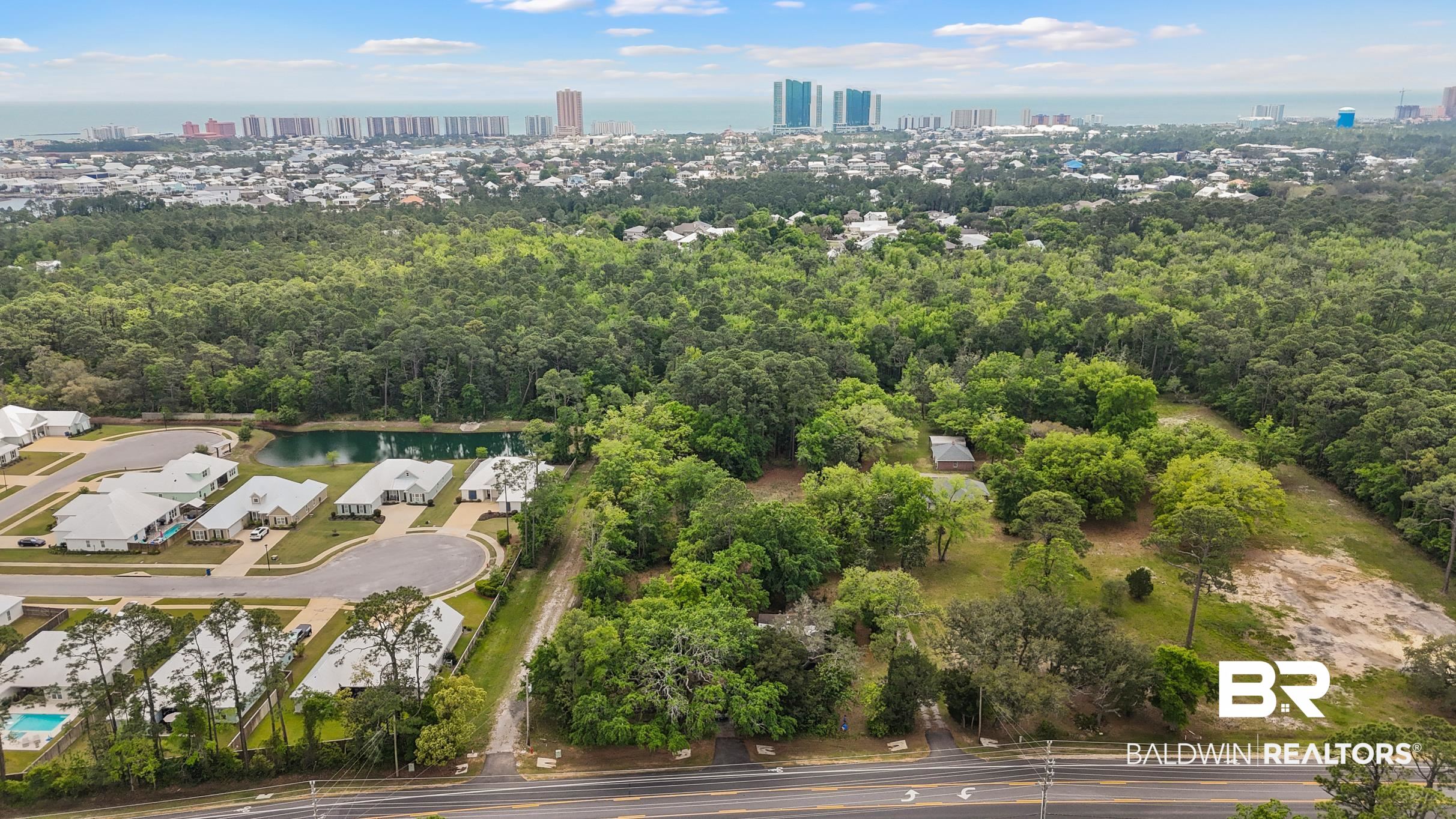 26486 Canal Road Orange Beach, AL 36561 - Photo 1 of 9 Aerial view featuring a view of city and a water view