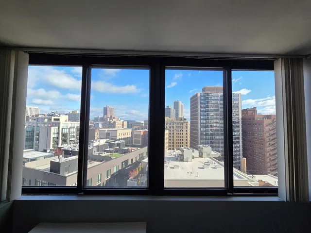 a lobby with furniture and floor to ceiling window