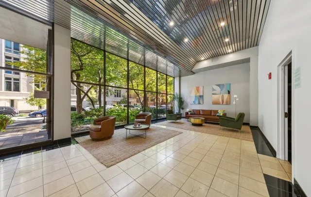 a living room with furniture and floor to ceiling window