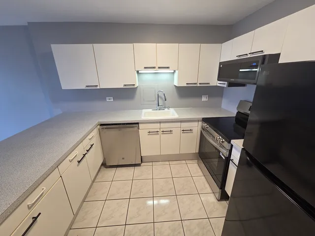 a kitchen with a sink a stove and refrigerator