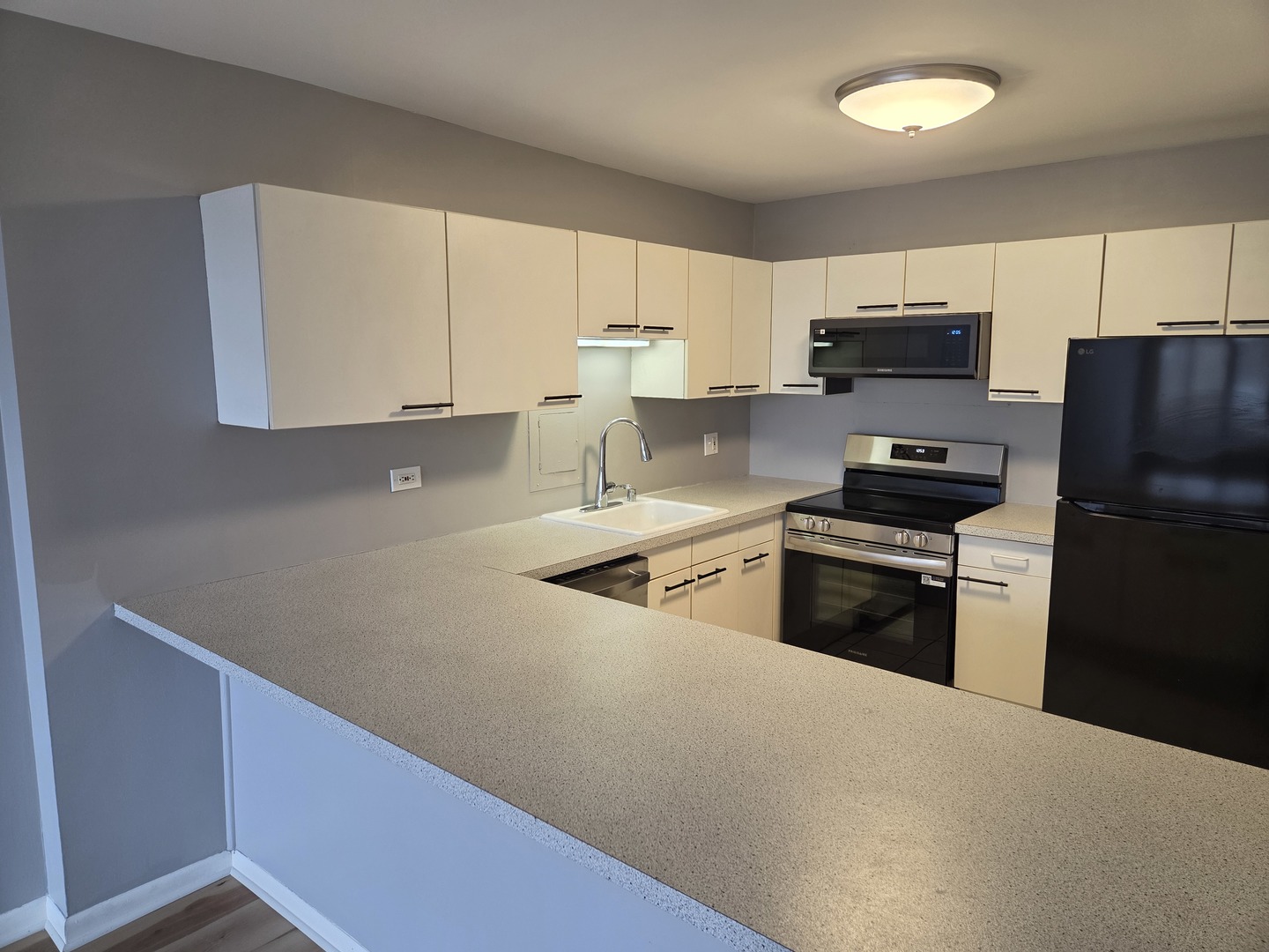 2754 North Hampden Court, Unit 1407 Chicago, IL 60614 - Photo 6 of 23 a kitchen with stainless steel appliances a refrigerator stove and microwave