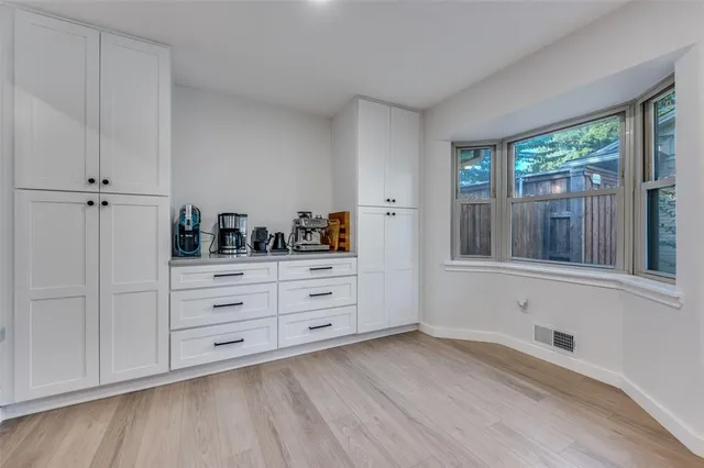 a room with a dresser and a window