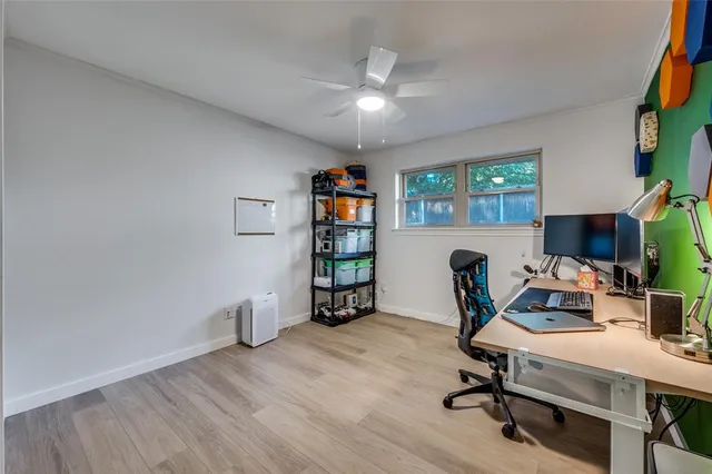 a view of a workspace with furniture and a window