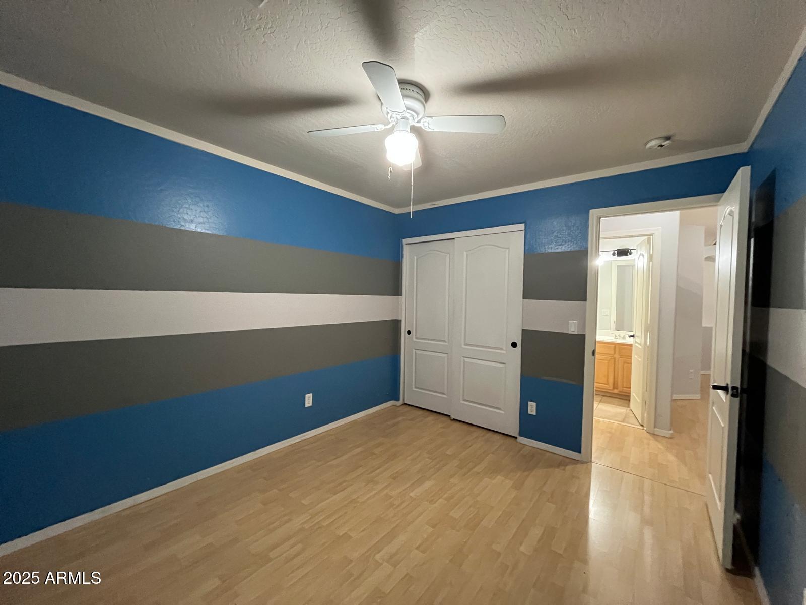18835 North 16th Place Phoenix, AZ 85024 - Photo 13 of 18 a view of an empty room with a ceiling fan