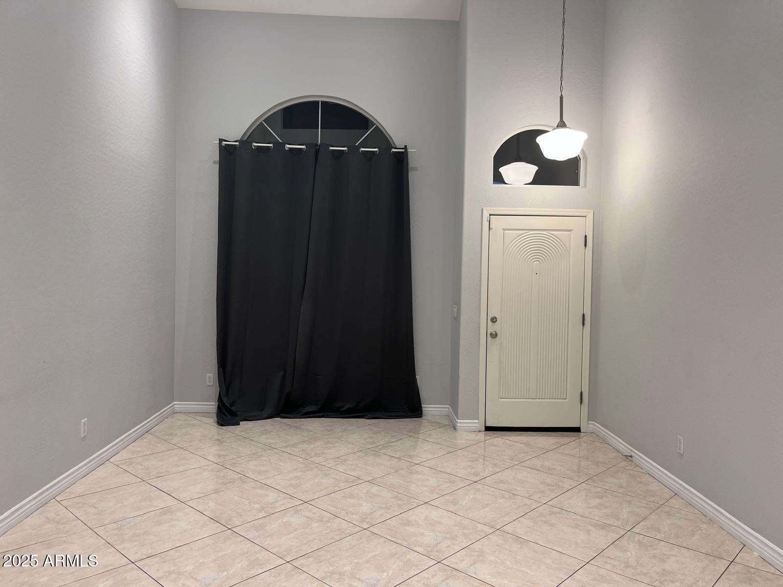 18835 North 16th Place Phoenix, AZ 85024 - Photo 5 of 18 an empty room with wooden door