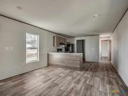 a view of a room with window and wooden floor