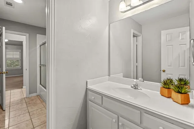 a bathroom with a sink a vanity and a mirror