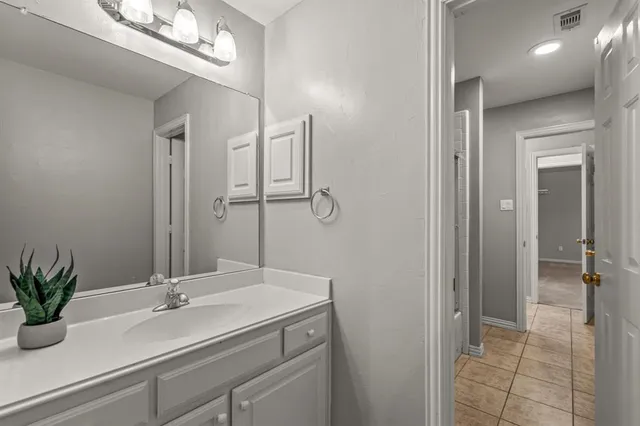 a bathroom with a sink a mirror and a shower