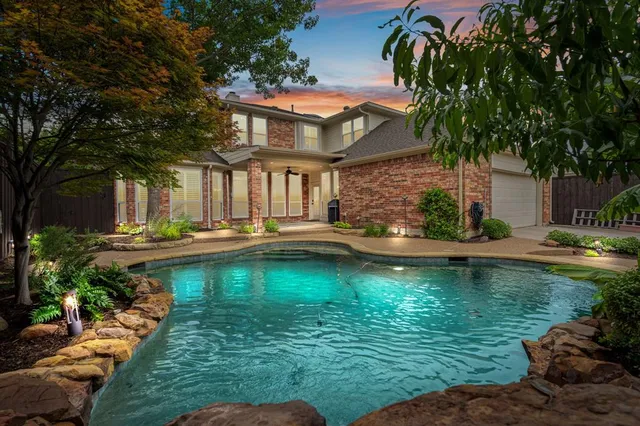 a view of a house with swimming pool and a yard