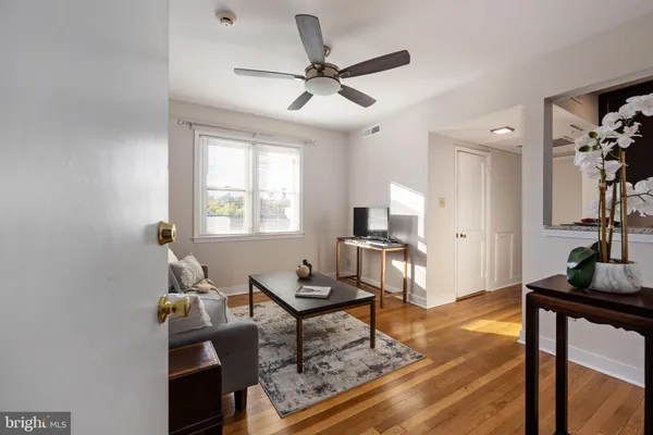 a living room with furniture a window and a flat screen tv
