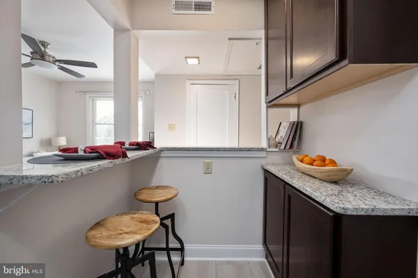 a kitchen with stainless steel appliances granite countertop a sink a refrigerator and a stove