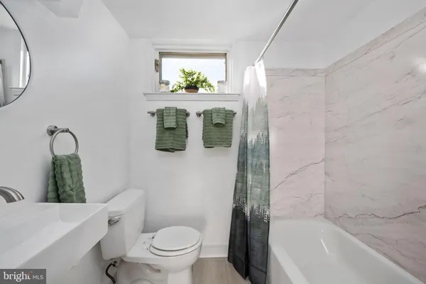 a bath room with a toilet and a bath tub