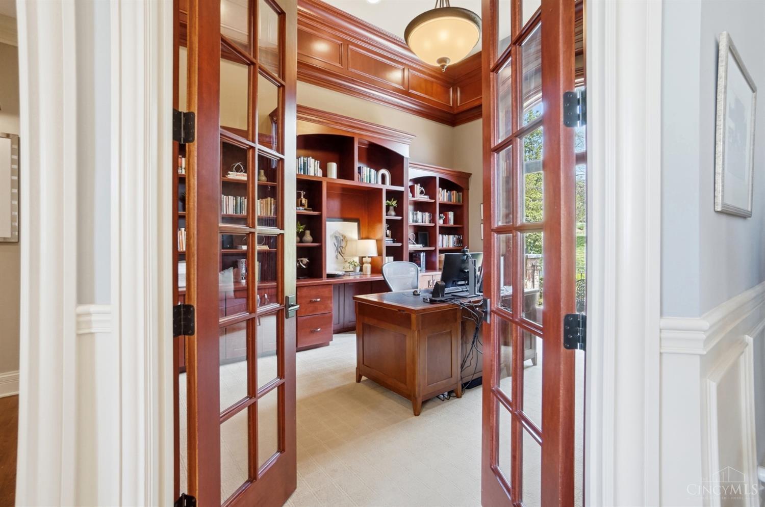 4535 Drake Road Cincinnati, OH 45243 - Photo 6 of 96 The first floor study has French doors, built-in bookshelves and wall to wall carpet.