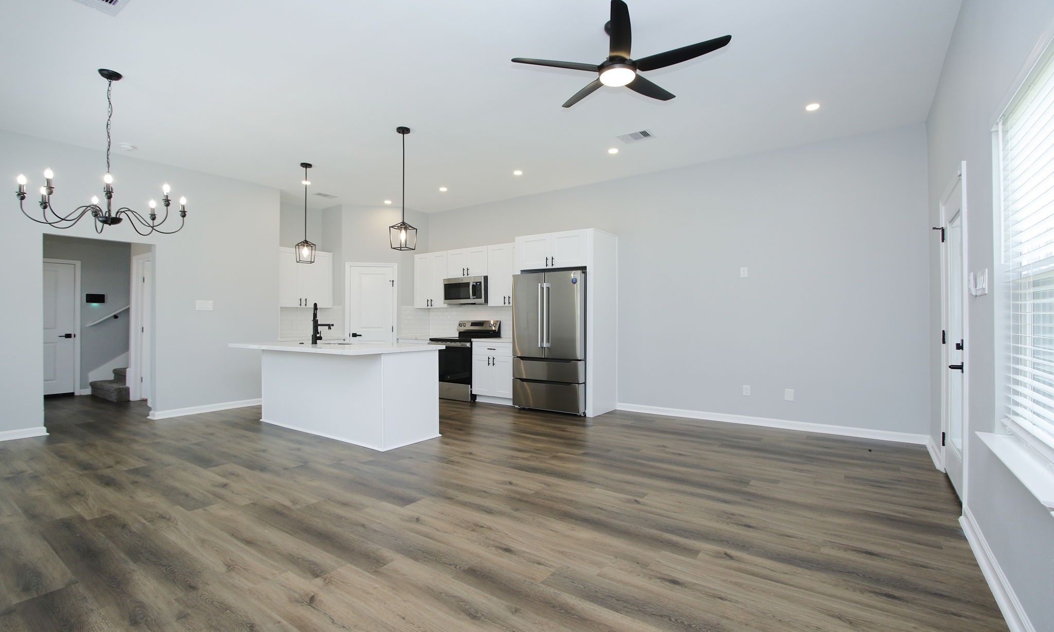 4337 Faulkner Street Houston, TX 77021 - Photo 12 of 39 a view of a kitchen with kitchen island stainless steel appliances wooden floor and living room view