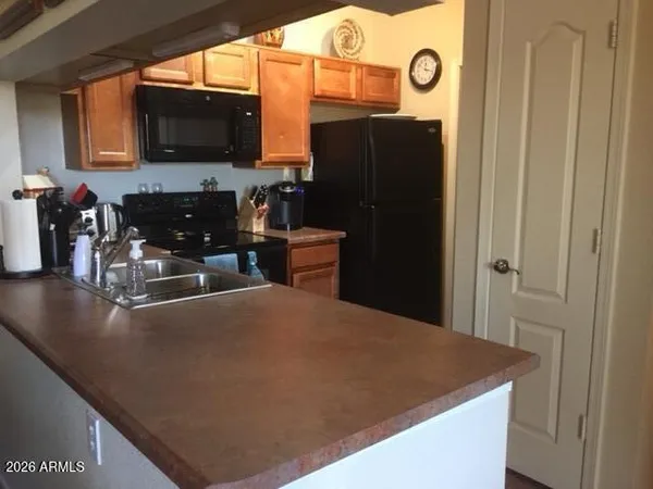 a kitchen with a refrigerator and a stove top oven