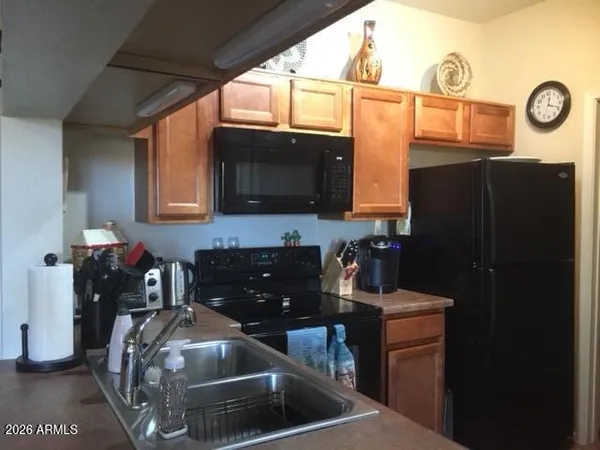 a kitchen with a refrigerator and a stove top oven