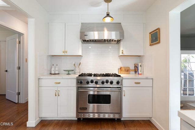 a kitchen with stainless steel appliances a stove a sink and a refrigerator