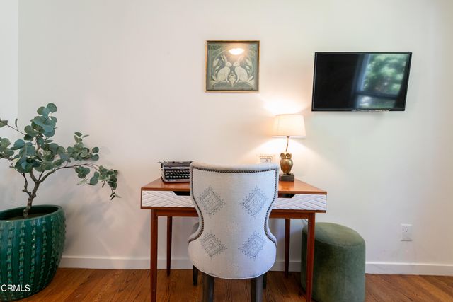 a view of a livingroom with furniture and a potted plant