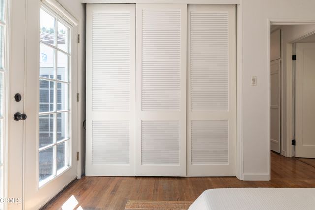 a view of bedroom with a bed and wooden floor