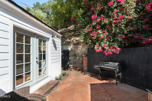 a flower garden is sitting in front of a house
