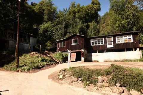 a view of a house with snow on the road