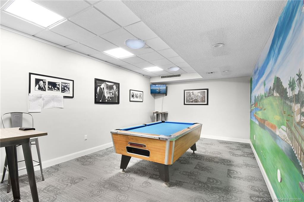 5413 Southeast Miles Grant Road, Unit G206 Stuart, FL 34997 - Photo 32 of 79 a room with pool table and window