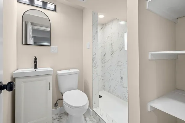 a bathroom with a toilet sink and shower