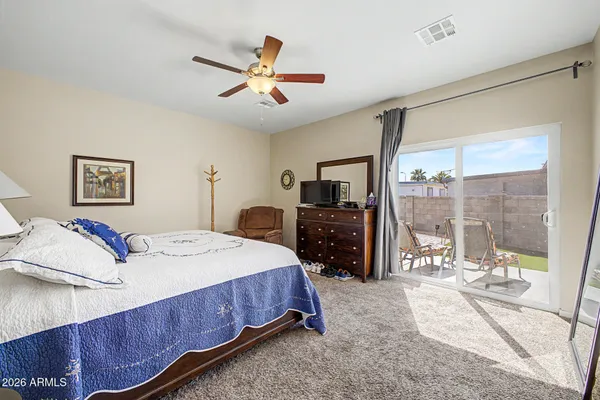 a bedroom with a bed and glass walk in closet