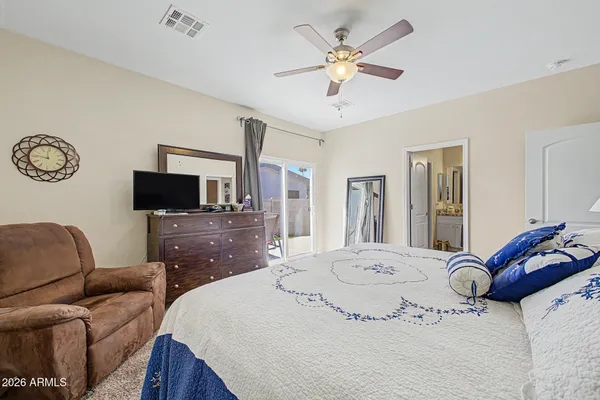 a living room with furniture a flat screen tv and a window