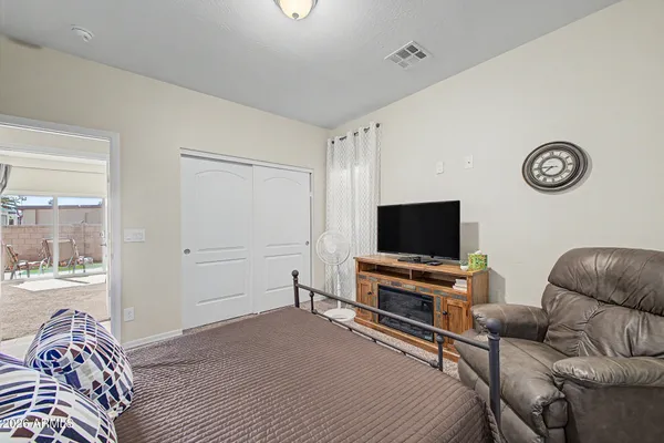 a bedroom with furniture and a flat screen tv