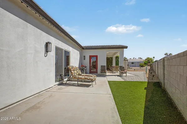 a view of a backyard with sitting area